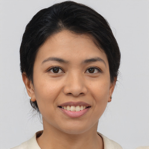 Joyful asian young-adult female with medium  black hair and brown eyes