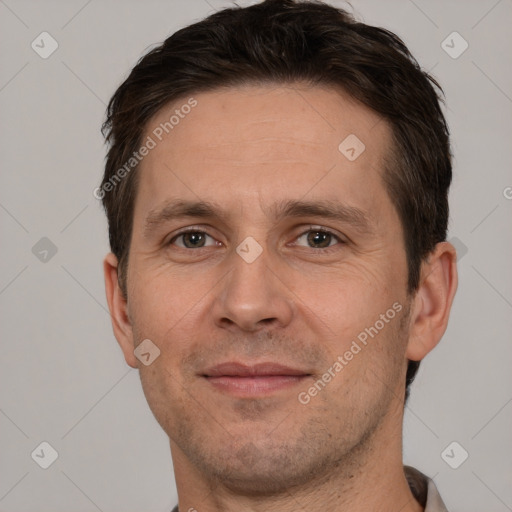 Joyful white adult male with short  brown hair and brown eyes