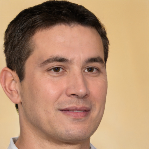 Joyful white young-adult male with short  brown hair and brown eyes