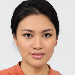 Joyful asian young-adult female with medium  black hair and brown eyes