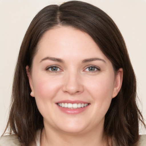 Joyful white young-adult female with medium  brown hair and brown eyes