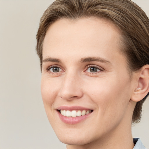 Joyful white young-adult female with medium  brown hair and grey eyes