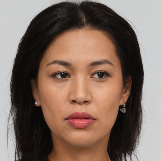 Joyful asian young-adult female with long  brown hair and brown eyes