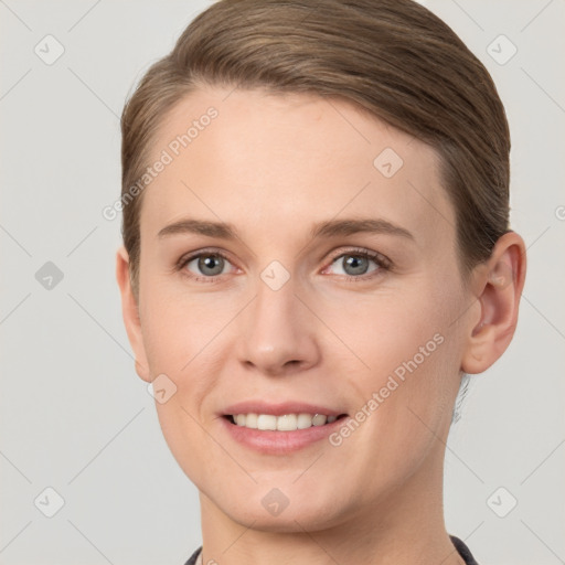 Joyful white young-adult female with short  brown hair and grey eyes