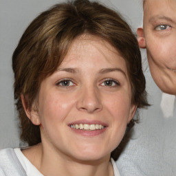 Joyful white adult female with medium  brown hair and blue eyes