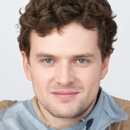 Joyful white young-adult male with short  brown hair and blue eyes