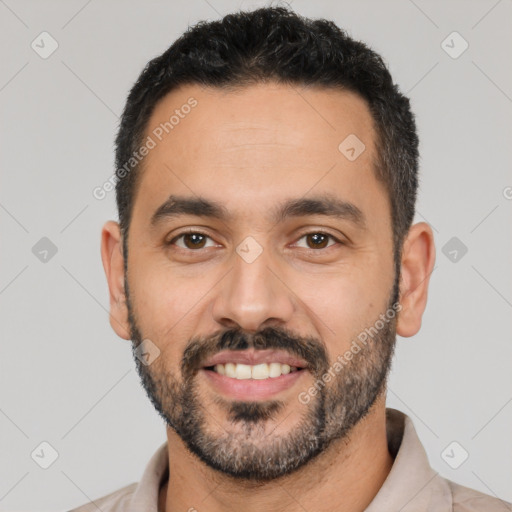 Joyful latino adult male with short  black hair and brown eyes