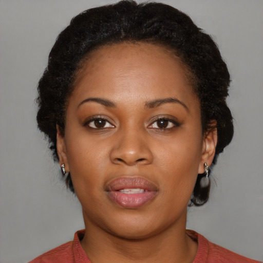 Joyful black young-adult female with medium  brown hair and brown eyes