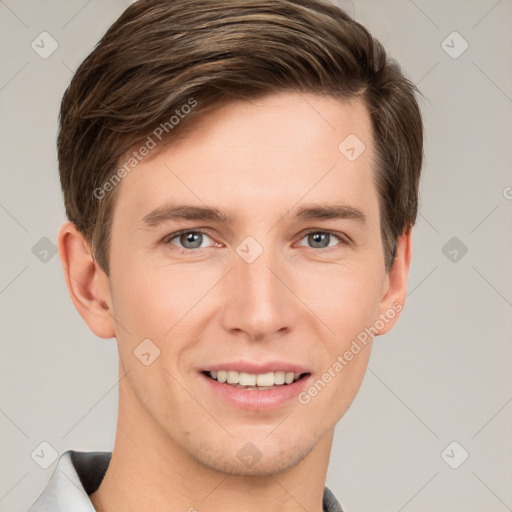 Joyful white young-adult male with short  brown hair and grey eyes