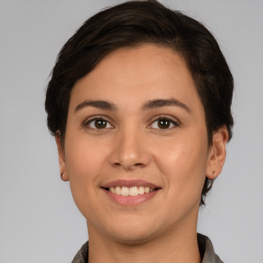Joyful white young-adult female with short  brown hair and brown eyes