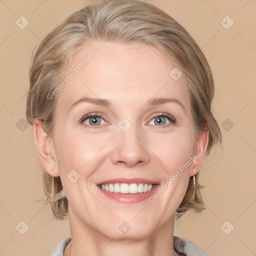 Joyful white adult female with medium  brown hair and blue eyes