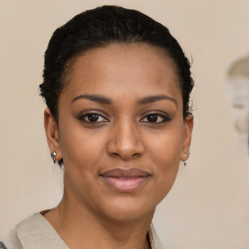 Joyful black young-adult female with short  black hair and brown eyes
