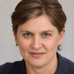 Joyful white adult female with medium  brown hair and grey eyes