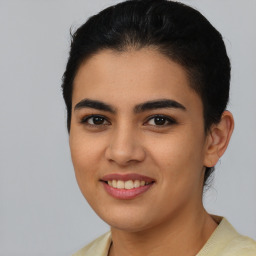 Joyful latino young-adult female with short  brown hair and brown eyes