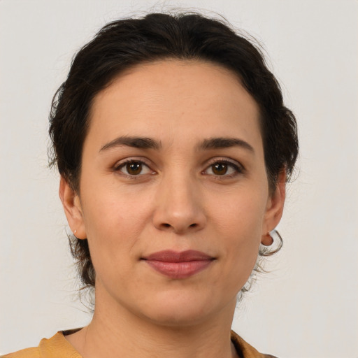 Joyful white young-adult female with medium  brown hair and brown eyes