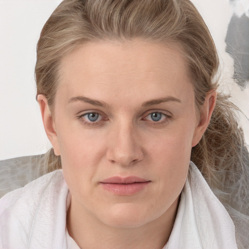 Joyful white young-adult female with medium  brown hair and blue eyes