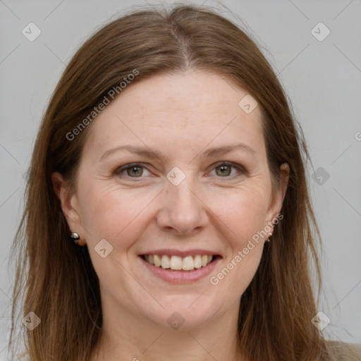 Joyful white adult female with long  brown hair and grey eyes