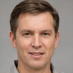 Joyful white adult male with short  brown hair and grey eyes