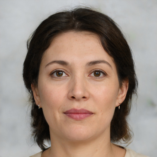 Joyful white adult female with medium  brown hair and brown eyes