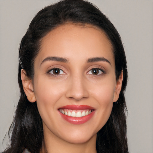 Joyful white young-adult female with long  black hair and brown eyes