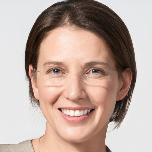 Joyful white adult female with medium  brown hair and grey eyes