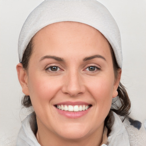 Joyful white young-adult female with medium  brown hair and blue eyes