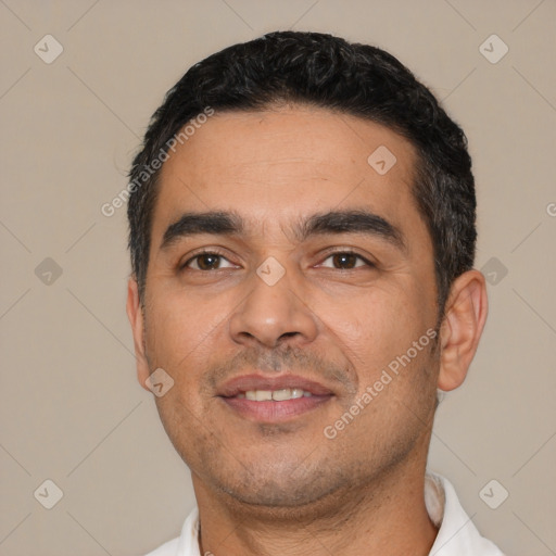 Joyful latino young-adult male with short  black hair and brown eyes