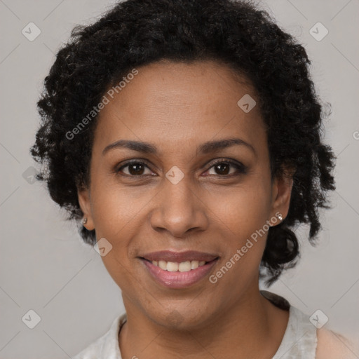 Joyful black adult female with short  brown hair and brown eyes