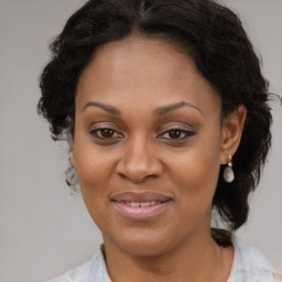 Joyful black adult female with medium  brown hair and brown eyes