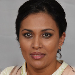 Joyful latino adult female with short  brown hair and brown eyes