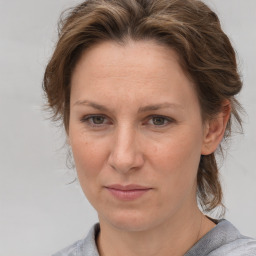 Joyful white adult female with medium  brown hair and grey eyes