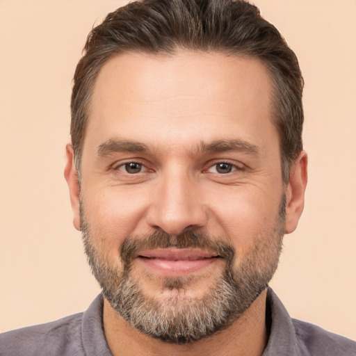 Joyful white adult male with short  brown hair and brown eyes