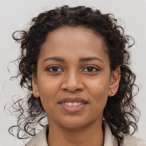 Joyful black young-adult female with medium  brown hair and brown eyes