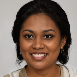 Joyful black young-adult female with medium  brown hair and brown eyes