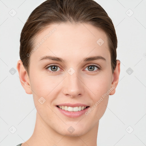 Joyful white young-adult female with short  brown hair and grey eyes