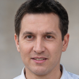 Joyful white adult male with short  brown hair and brown eyes