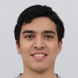 Joyful asian young-adult male with short  black hair and brown eyes