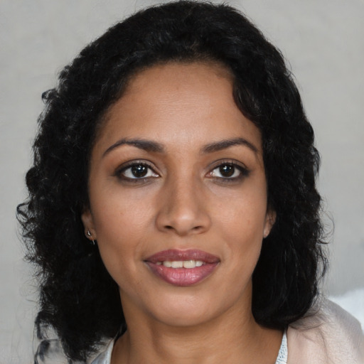 Joyful latino young-adult female with medium  black hair and brown eyes