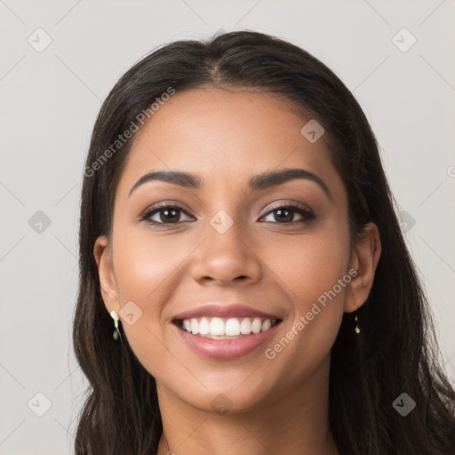 Joyful latino young-adult female with long  brown hair and brown eyes