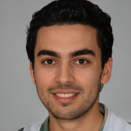 Joyful white young-adult male with short  black hair and brown eyes