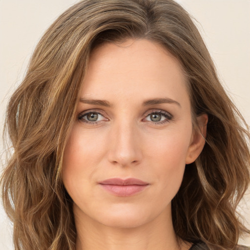 Joyful white young-adult female with long  brown hair and green eyes