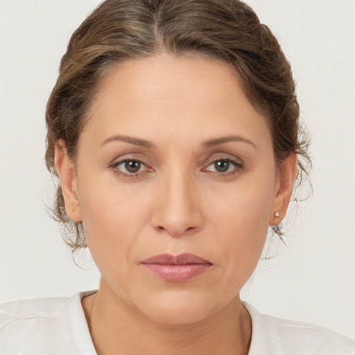 Joyful white adult female with medium  brown hair and brown eyes