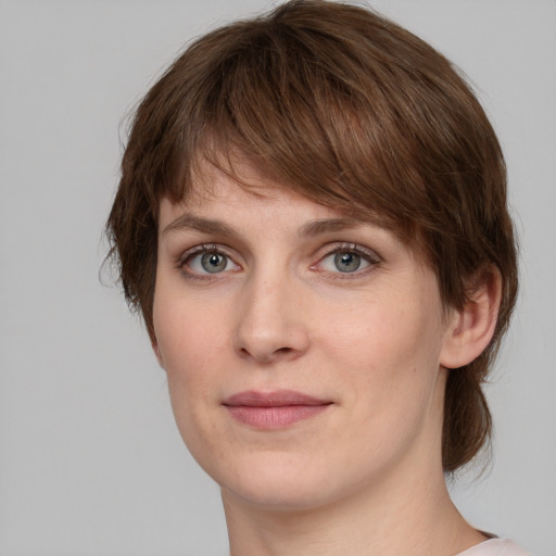 Joyful white young-adult female with medium  brown hair and grey eyes