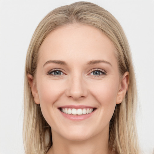 Joyful white young-adult female with long  brown hair and blue eyes