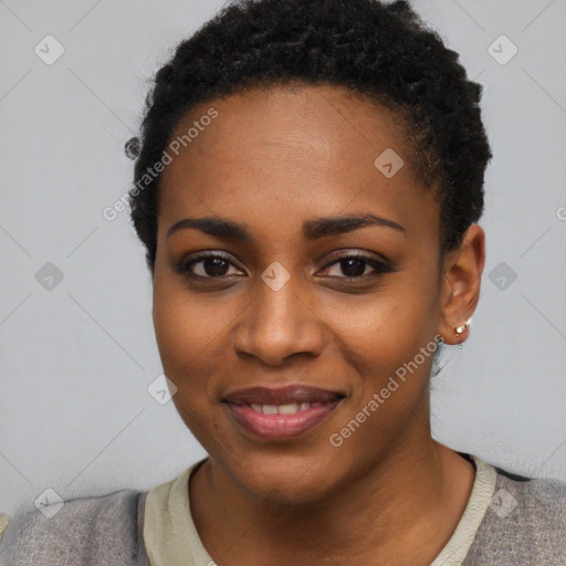 Joyful black young-adult female with short  black hair and brown eyes