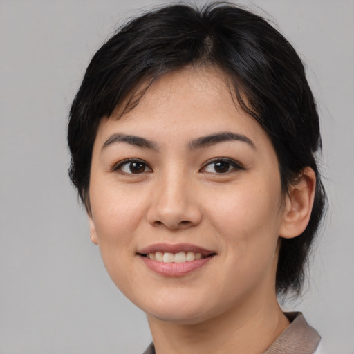 Joyful asian young-adult female with medium  brown hair and brown eyes