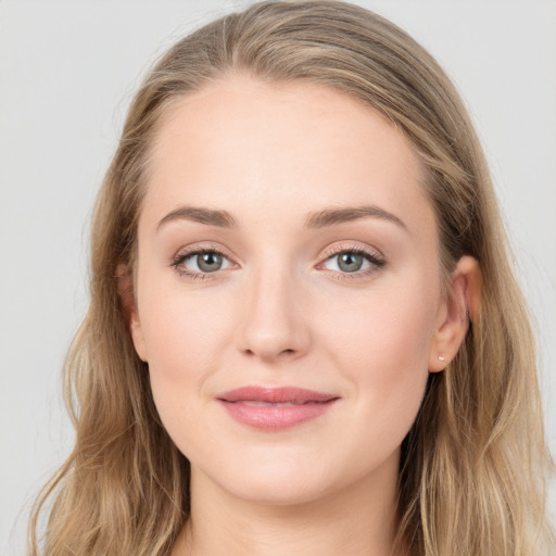 Joyful white young-adult female with long  brown hair and blue eyes