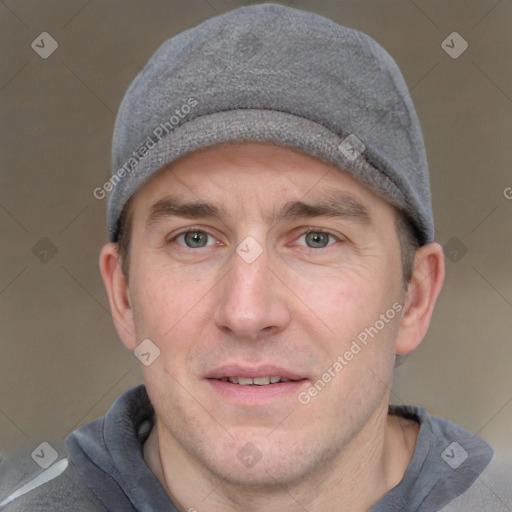 Joyful white adult male with short  brown hair and grey eyes