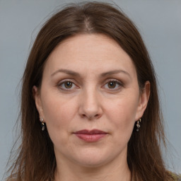 Joyful white adult female with long  brown hair and grey eyes