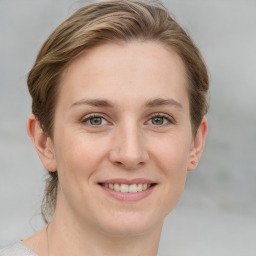 Joyful white young-adult female with medium  brown hair and blue eyes